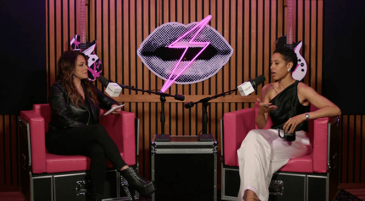 Melinda Colaizzi in conversation with a guest on the Women Who Rock set